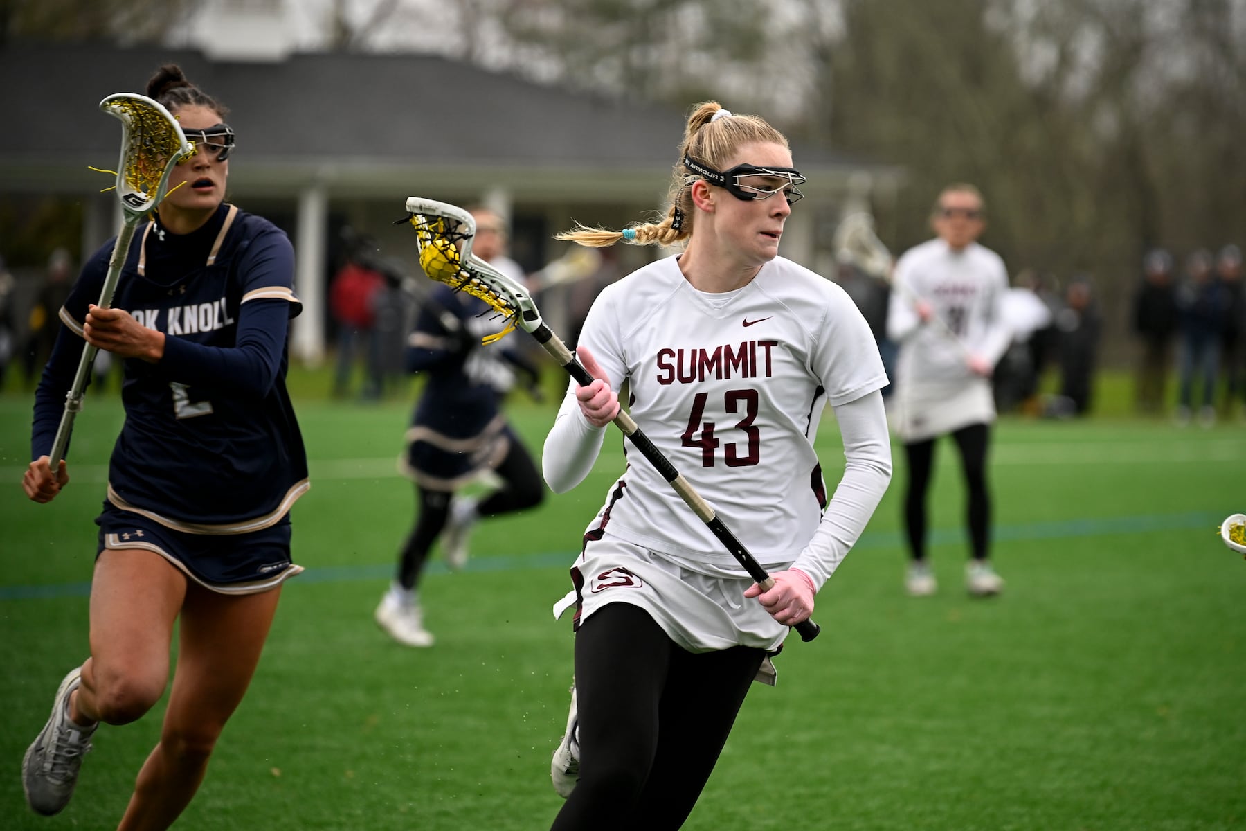 Susannah O'Connell (43) of Summit gets past the defender Maris Mcginty (2) of Oak Knoll during the girls lacrosse game between Oak Knoll and Summit at Oak Knoll High School in Chatham, NJ on Saturday, April 12, 2025.