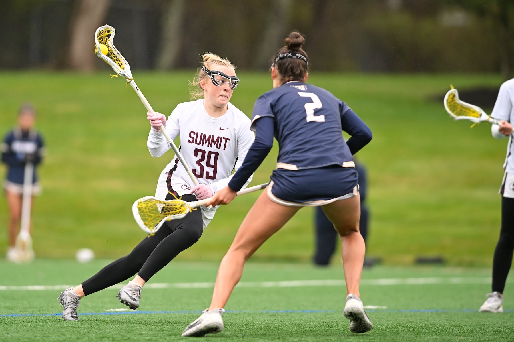 Nell Ducey (39) of Summit looks to get past defender Maris Mcginty (2) of Oak Knoll during the girls lacrosse game between Oak Knoll and Summit at Oak Knoll High School in Chatham, NJ on Saturday, April 12, 2025.