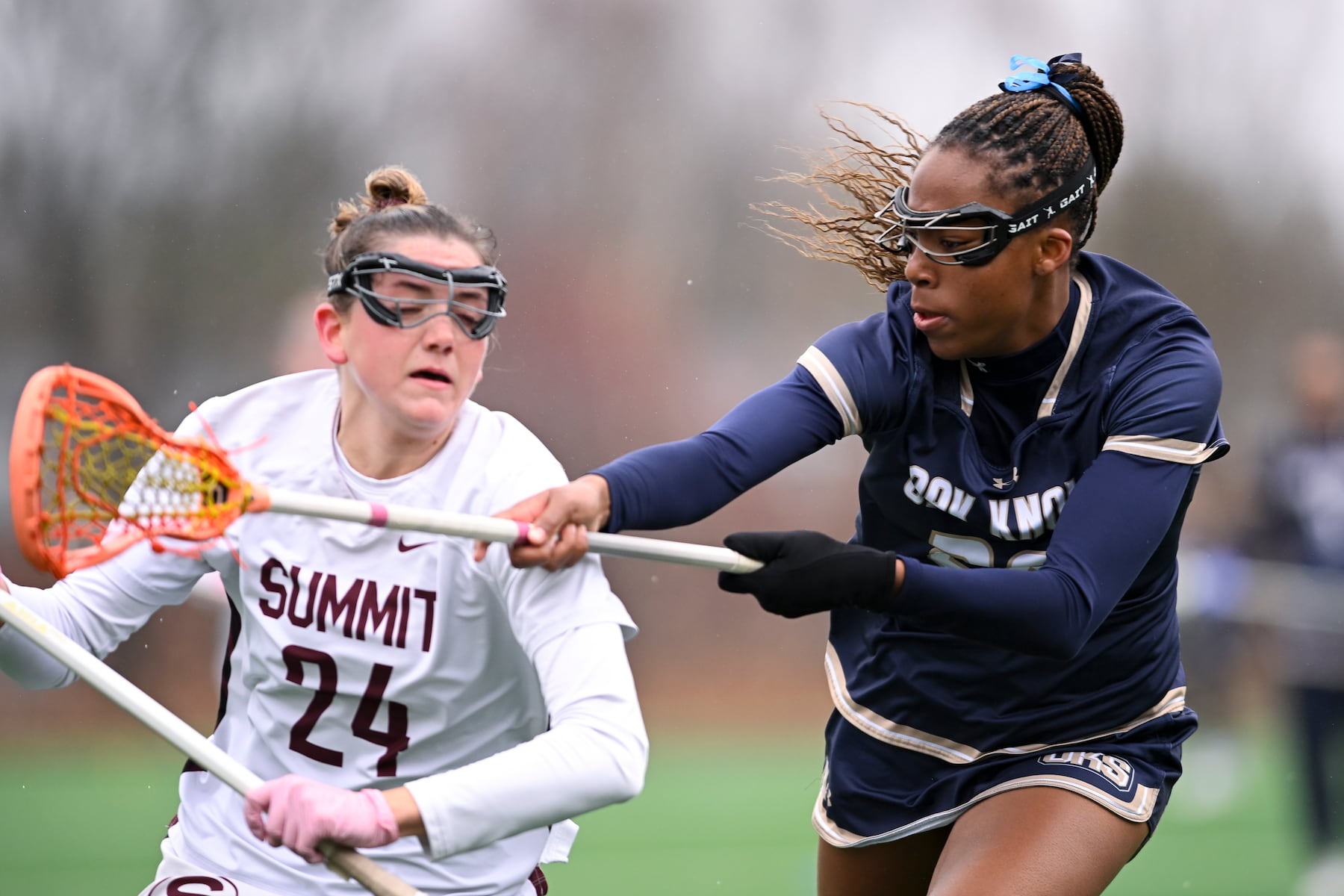 Gaelle Jones (28) of Oak Knoll defends Molly Davies (24) of Summit during the girls lacrosse game between Oak Knoll and Summit at Oak Knoll High School in Chatham, NJ on Saturday, April 12, 2025.