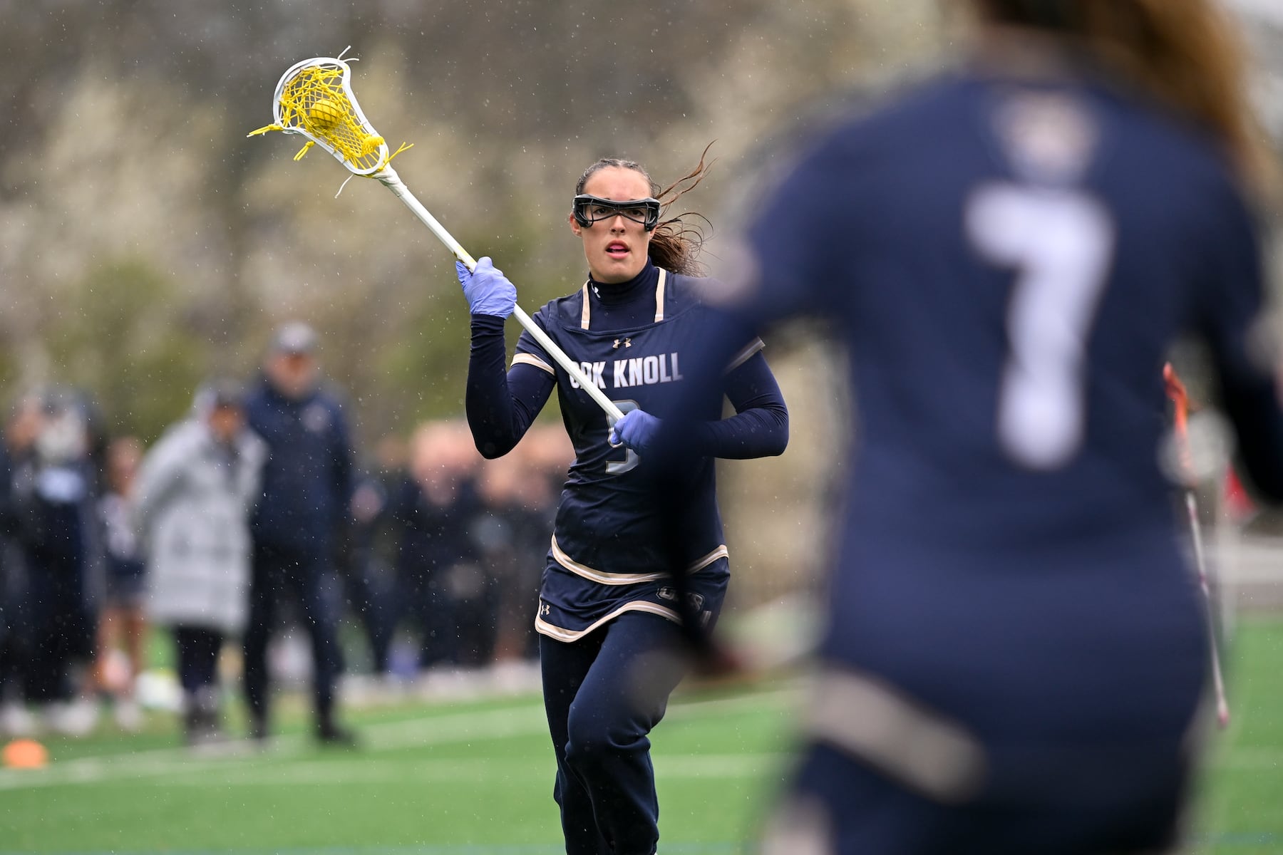 Grace Koetje (9) of Oak Knoll looks to pass the ball to Sophia McBride (7) of Oak Knoll during the girls lacrosse game between Oak Knoll and Summit at Oak Knoll High School in Chatham, NJ on Saturday, April 12, 2025.