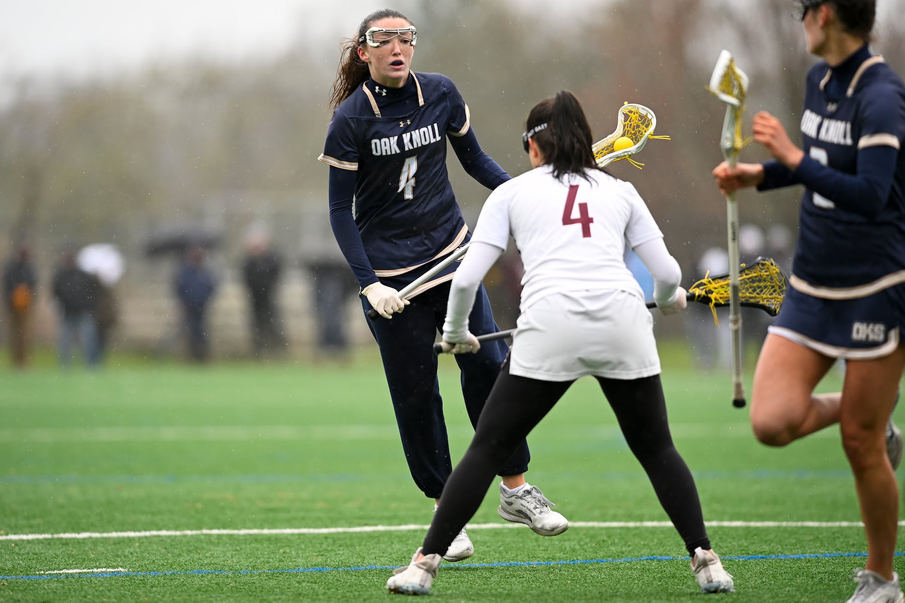 Beatrice Burton (4) of Oak Knoll looks to get past Sara Scallon (4) of Summit during the girls lacrosse game between Oak Knoll and Summit at Oak Knoll High School in Chatham, NJ on Saturday, April 12, 2025.