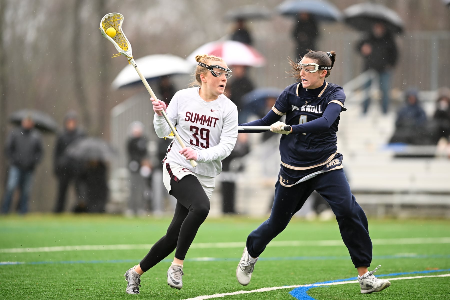 Nell Ducey (39) of Summit gets past defender Beatrice Burton (4) of Oak Knoll during the girls lacrosse game between Oak Knoll and Summit at Oak Knoll High School in Chatham, NJ on Saturday, April 12, 2025.