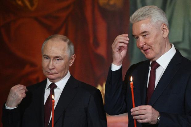 Russian President Vladimir Putin, left, and Moscow Mayor Sergei Sobyanin...