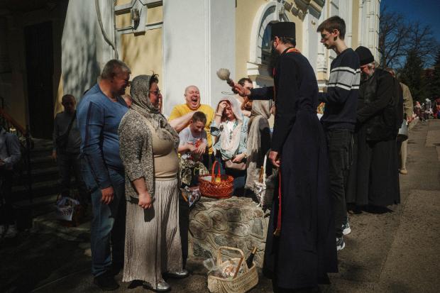 A priest blesses Easter baskets during the celebration of Orthodox...
