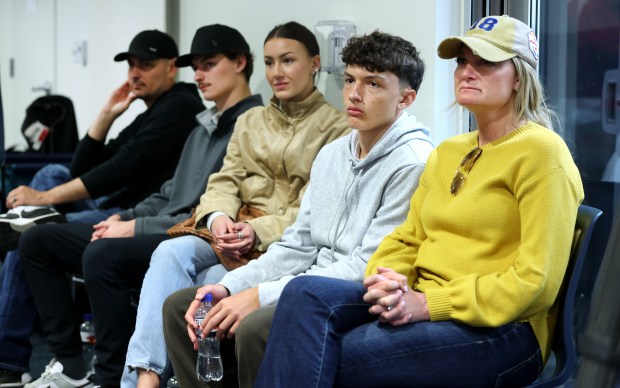 The family of tight end Colston Loveland listen as the...