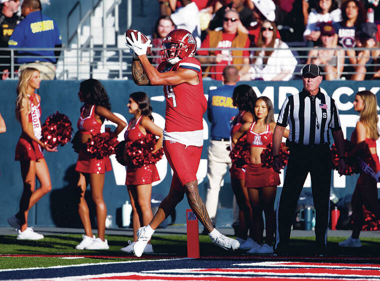 MARK J. REBILAS / IMAGN IMAGES / NOV. 30
Arizona Wildcats wide receiver Tetairoa McMillan catches a touchdown against the Arizona State Sun Devils during the Territorial Cup at Arizona Stadium in November. Waimanalo-born McMillan was chosen eighth by the Carolina Panthers in todays NFL Draft.