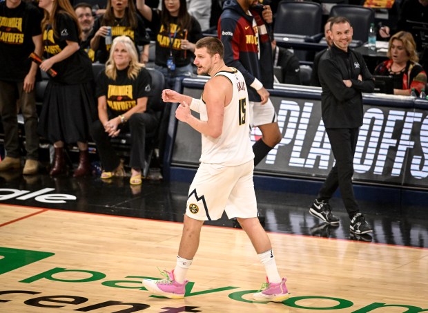 Head coach David Adelman of the Denver Nuggets smiles as...