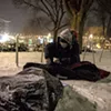 A woman with a tent she received in Burlington's City Hall Park