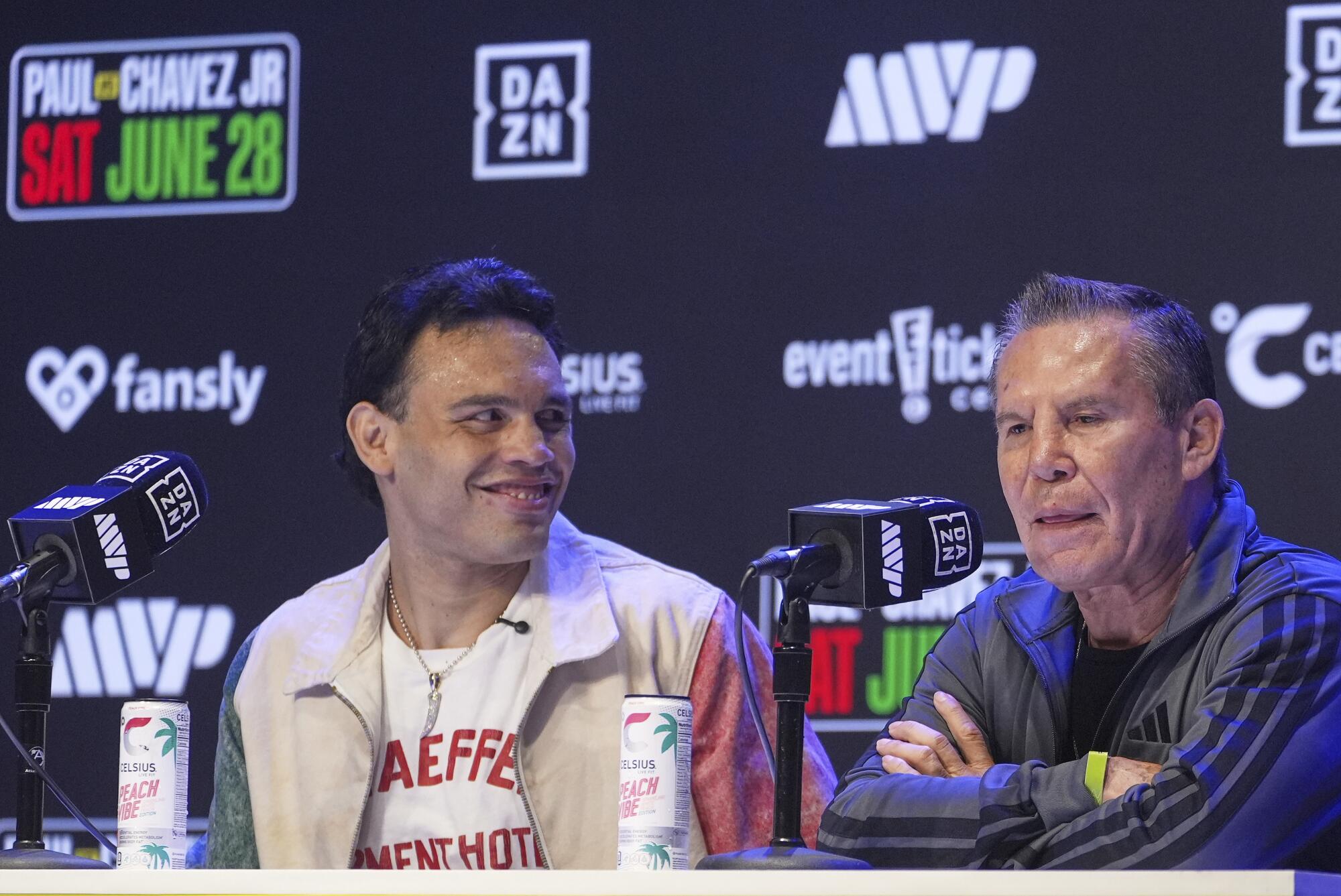 Boxers Julio César Chávez Jr. and his father, Julio César Chávez Sr., sit beside each other during a news conference.