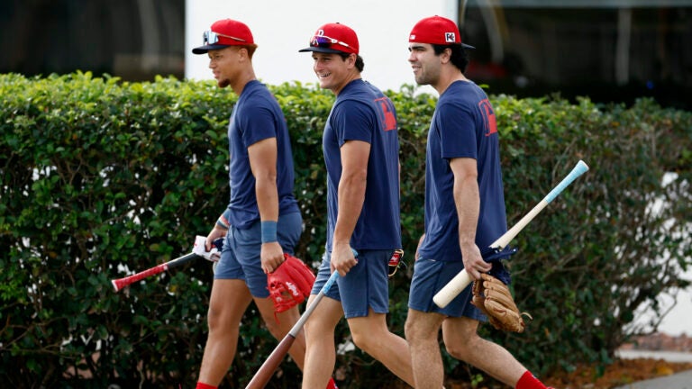 Boston Red Sox prospects Kristian Campbell, Roman Anthony and Marcelo Mayer walk onto the fields for first day of spring training at JetBlue Park.