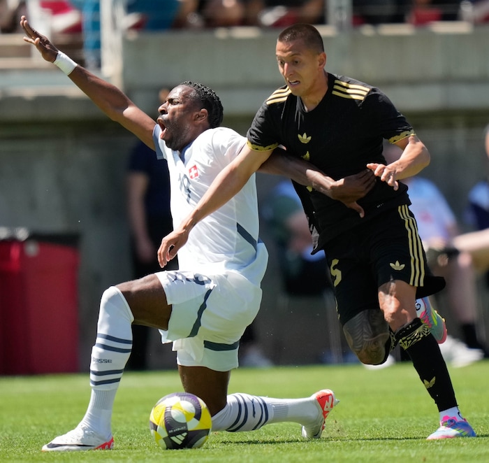 (Francisco Kjolseth  | The Salt Lake Tribune) Mexico’s Roberto Alvarado, 25, collides with Ulisses Garcia, 19, of Switzerland as the Mexico Men’s National Team takes on Switzerland in a MexTour match at Rice-Eccles Stadium on Saturday, June 7, 2025.