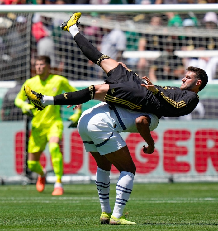 (Francisco Kjolseth  | The Salt Lake Tribune) Santiago Jimenez, 11, of Mexico finds himself on the back of Switzerland’s Manuel Akanji, 5, after a header attempt as the Mexico Men’s National Team takes on Switzerland in a MexTour match at Rice-Eccles Stadium on Saturday, June 7, 2025.