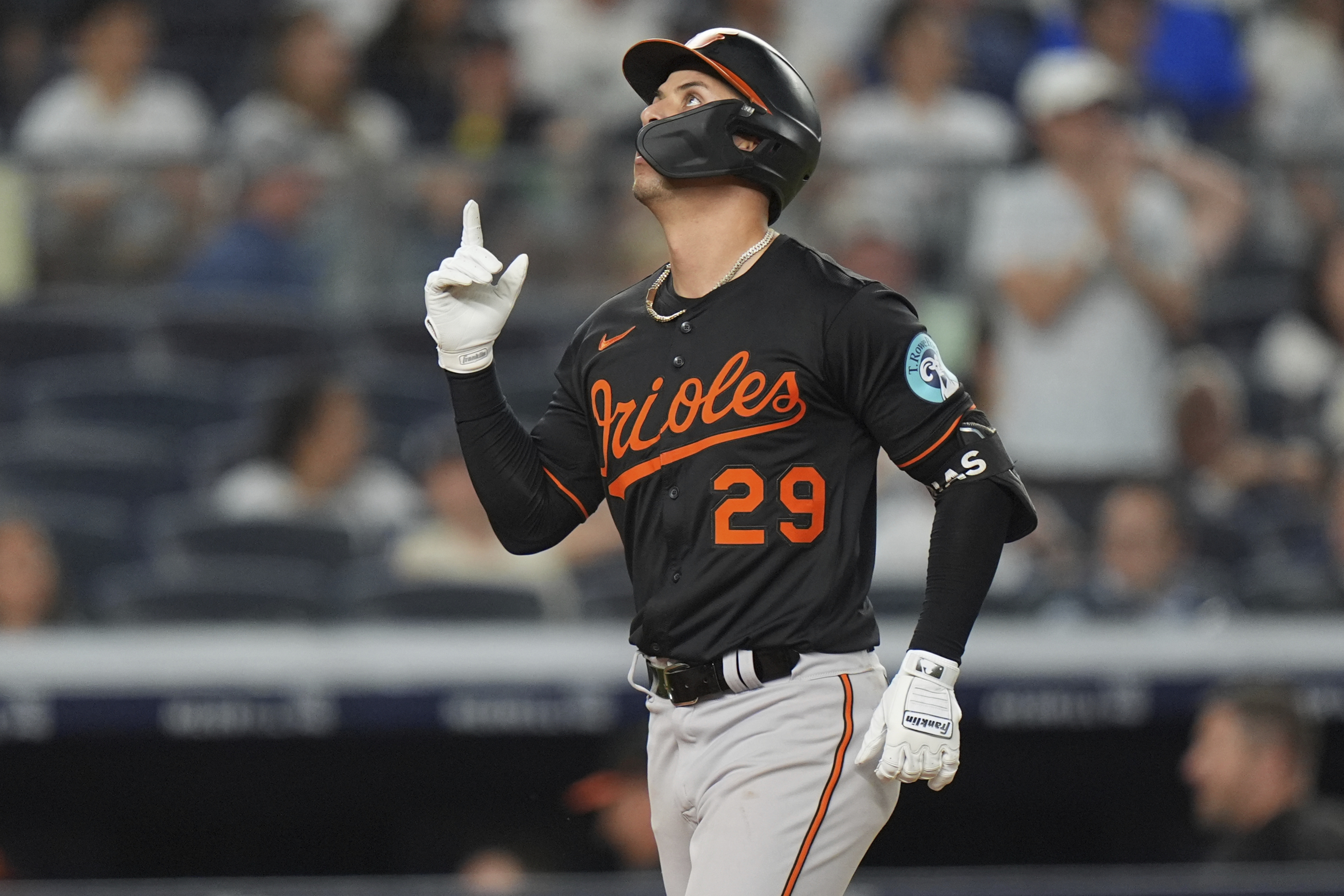 Baltimore Orioles' Ramón Urías gestures as he runs the bases...