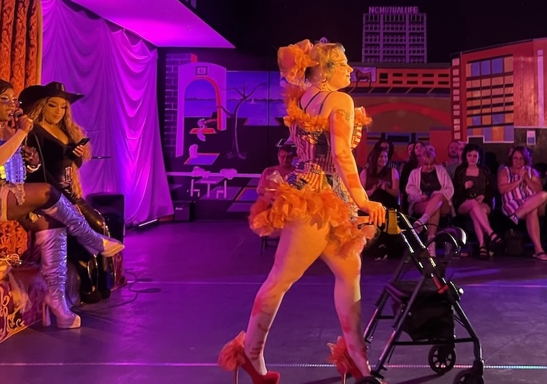 Lorraine Dillard models a design by her brother Marcus Dillard, featuring stitched-together American flags. Photo by Marin Yearley — The 9th Street Journal