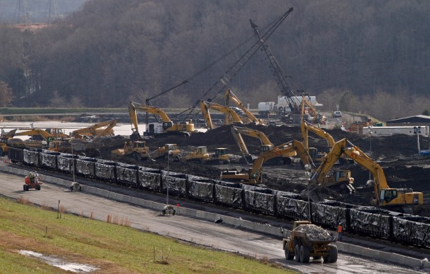 Fly ash is loaded into plastic-lined rail cars at the Tennessee Valley Authority's Kingston Fossil Plant on Thursday, Dec. 17, 2009, in Kingston, Tennessee. (AP Photo/Wade Payne)