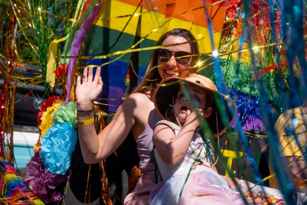 Marissa Soeffing waves as her daughter, 4-year-old Eira Soeffing, sits...