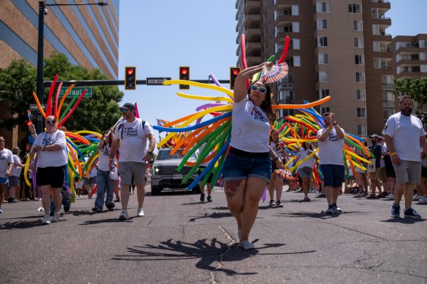 Misty Maestas with JP Morgan Chase dances down 17th Avenue...