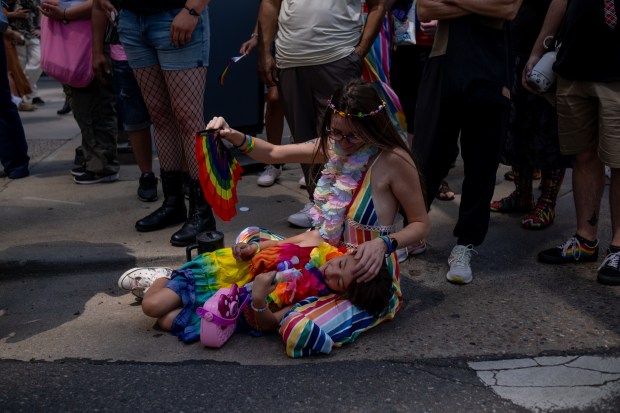 Eleanor, 6, rests on her mom, Emily, at the Denver...