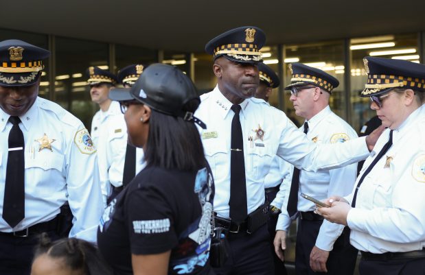 Chicago police Superintendent Larry Snelling, center, greets commanders and chiefs after a memorial roll call and gathering in memory of Officer Aréanah M. Preston, on the two-year anniversary of her death, at the 5th District station, 727 E. 111th St., May 6, 2025. (John J. Kim/Chicago Tribune)