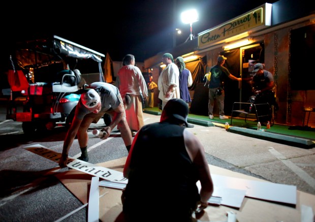 Crew members transform Chic's Beach's Green Parrot during filming of 'The Pirate King' on Wednesday, July 2, 2025. (Stephen M. Katz / The Virginian-Pilot)