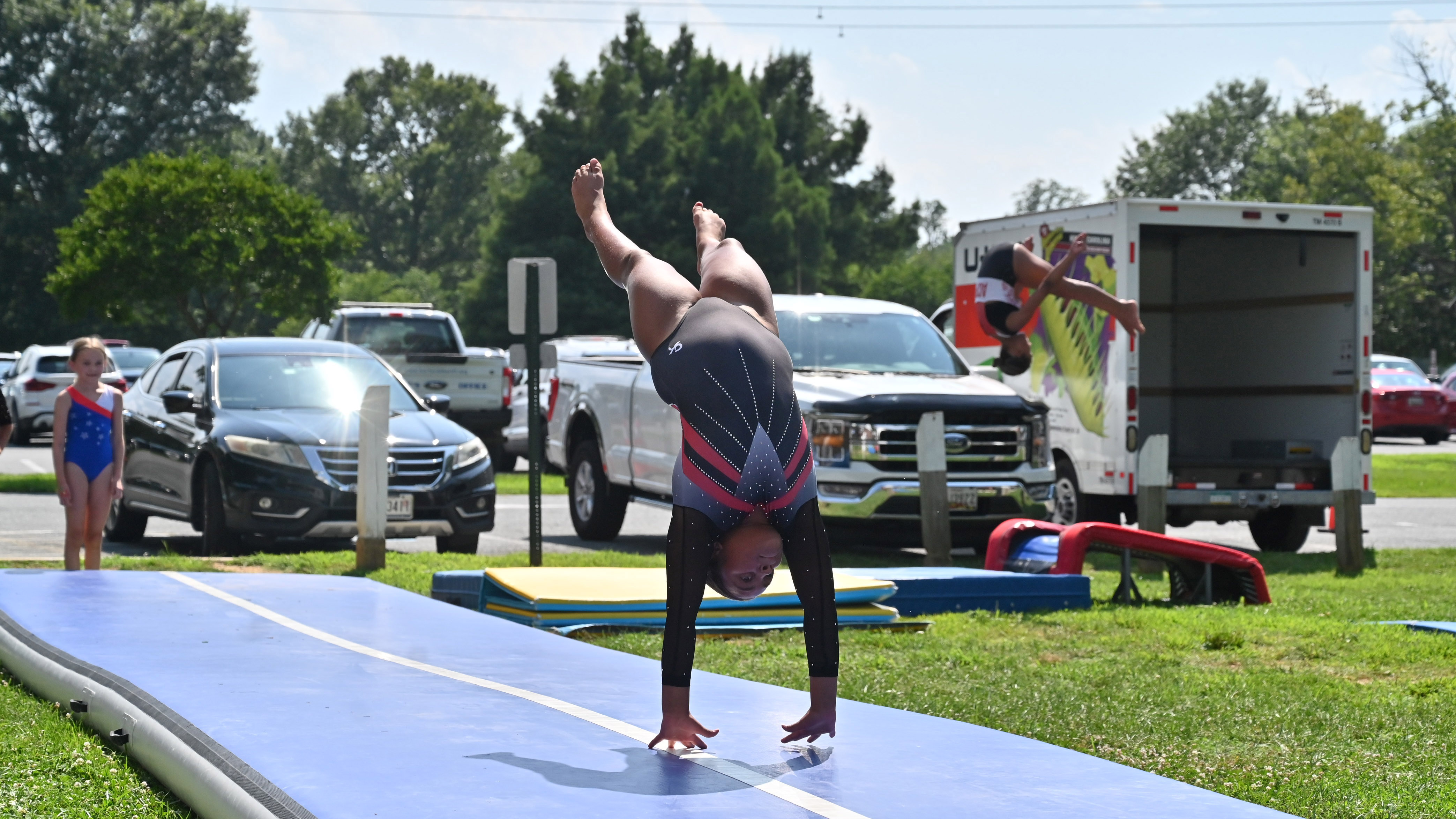 Talya Darby performs a tumbling routine with ACPR Gymnastics during a demonstraton for Harford County Parks and Recreation Day at Flying Point Park on Friday. (Brian Krista/Staff)
