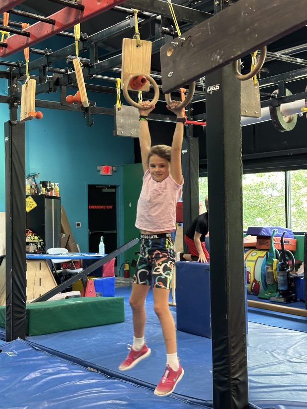 Raygen Slokovitz, 7, a ninja warrior and a wrestler, at the Ninja Warrior gym at WISC. "I feel like it really makes me stronger," she says. Kim O'Brien Root/staff