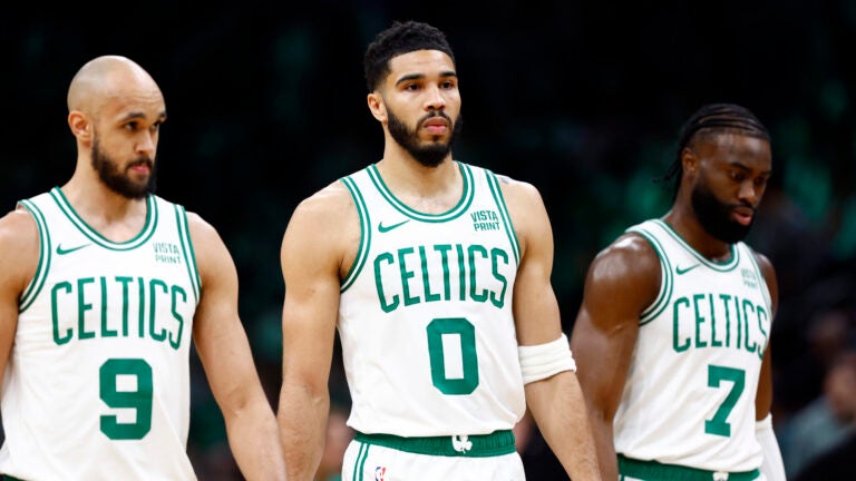 Boston Celtics guard Derrick White (9), forward Jayson Tatum (0) and guard Jaylen Brown (7) walk onto the court during the first quarter in game one of the second round of the NBA Eastern Conference playoffs at TD Garden.