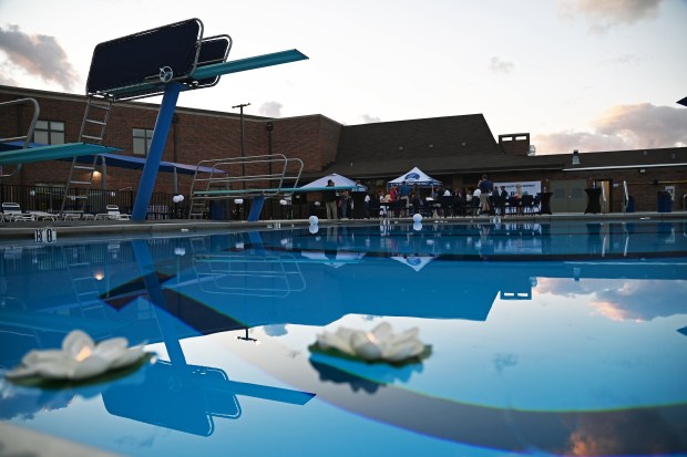 Illuminated water flowers move across the pool surface during the VIP Pool Party at Blair Park pool in Lake Bluff on Aug. 26, 2025. (Karie Angell Luc/Pioneer Press)