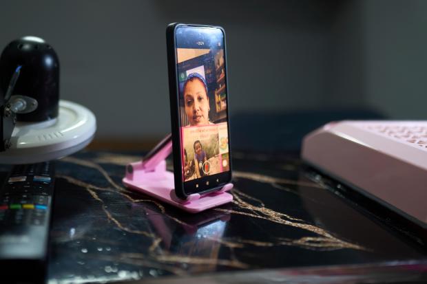 Syntia Caceres records a video to post on social media...