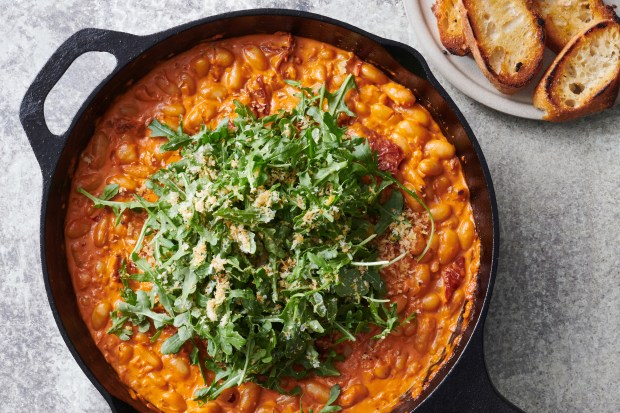 Creamy, spicy tomato beans and greens. This weeknight wonder is for those who delight in turning a modest can of beans into a spectacular dinner. Food styled by Samantha Seneviratne. (Kelly Marshall, The New York Times)