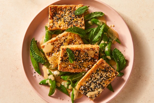 Lemon-pepper tofu and snap peas. This combination of sesame and pepper-crusted tofu, blistered snap peas and tahini-lemon sauce creates a lively and quick dinner, while the three elements are just as valuable as building blocks to many more meals. Food styled by Samantha Seneviratne. (Julia Gartland, The New York Times)