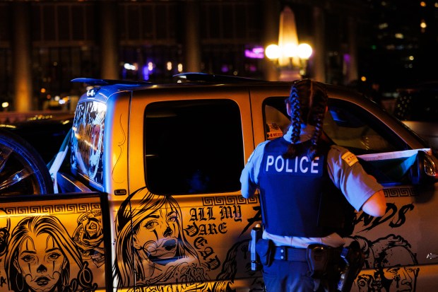 Chicago Police check a vehicle with a Mexican flag near Michigan Avenue as vehicles gather to celebrae Mexican Independence Day, Sept. 13, 2025. (Armando L. Sanchez/Chicago Tribune)