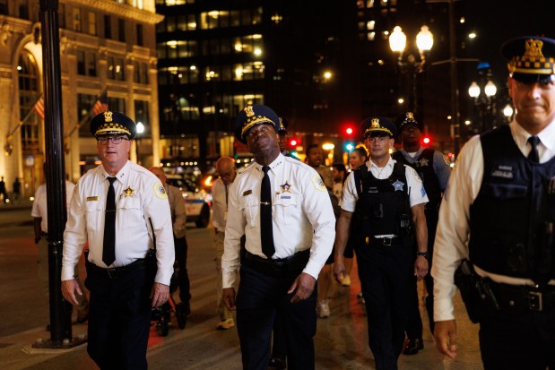 Chicago Police Superintendent Larry Snelling walks near Michigan Avenue while officers check vehicles with Mexican flags mounted on wooden poles people gather while celebrating Mexican Independence Day, Sept. 13, 2025. (Armando L. Sanchez/Chicago Tribune)