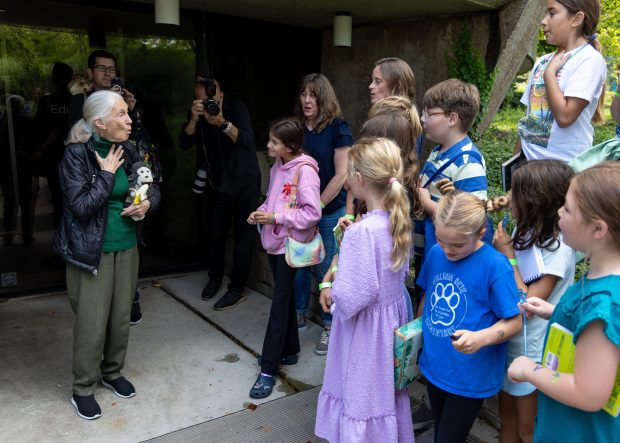 Jane Goodall shows children from Oak Park's William Beye Elementary School's "Green Team" how to hoot like a chimpanzee on Sept. 13, 2025, at the Lincoln Park Zoo in Chicago. (Dominic Di Palermo/Chicago Tribune)