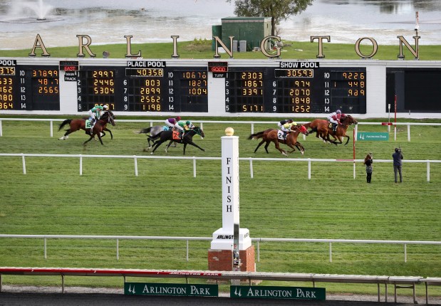Horses cross the finish line on the final race day ever at Arlington International Racecourse on Sept. 25, 2021. (Chris Sweda/Chicago Tribune)