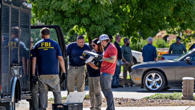 FBI agents outside Tyler Robinson’s parents’ home in Washington, Utah.