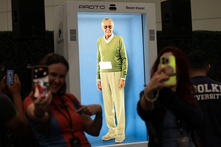 MARIO ANZUONI / REUTERS
                                Attendees take selfies in front of an AI hologram of comic book writer Stan Lee projected into a Proto Epic device during L.A. Comic Con in Los Angeles today.