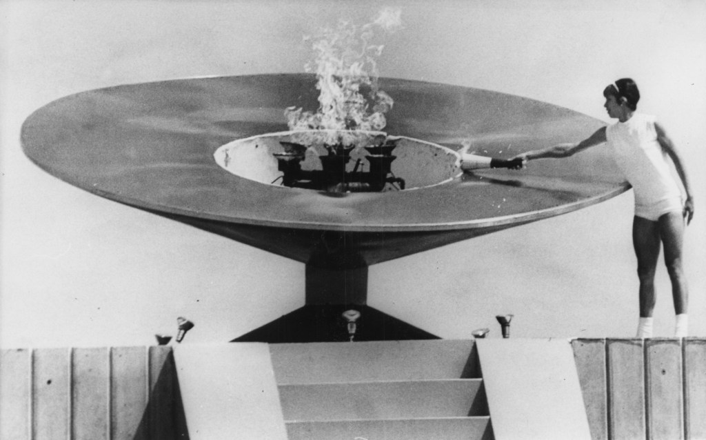 October 12, First woman lights Olympic flame