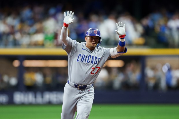 Cubs' Seiya Suzuki runs the bases after hitting a three-run...