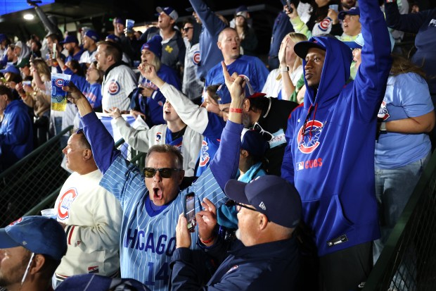 Cubs fans celebrate after a Cubs Game 3 victory over...