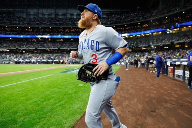 Cubs first baseman Justin Turner walks on the field before...