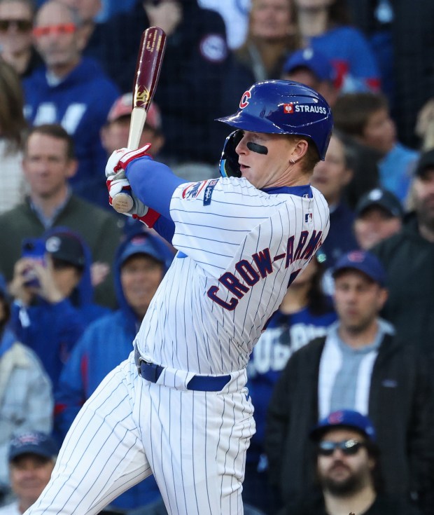 Cubs first baseman Michael Busch celebrates while rounding the bases...