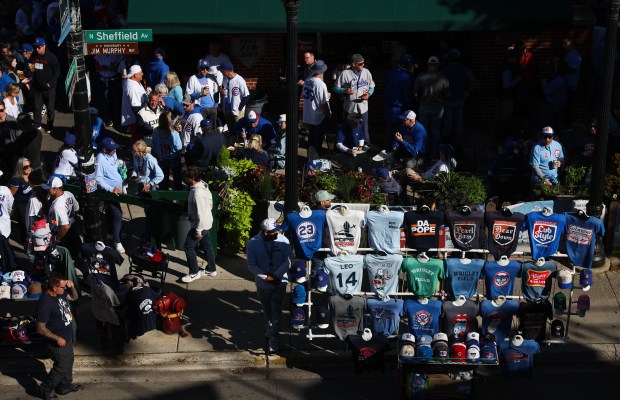 Fans mingle outside a pub on North Sheffield Avenue before...