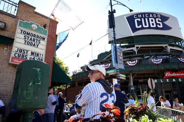 Fans gather outside of Wrigley Field in Chicago before Game...