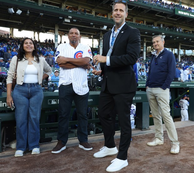 Former Cubs pitcher Carlos Zambrano, center left, waits to throw...