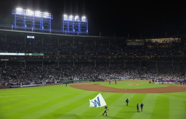 Cubs mascot Clark waves a "W" flag after a 6-0...