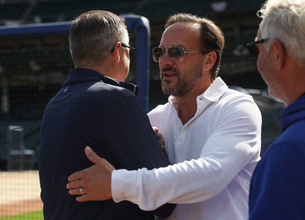 Cubs Chairman Tom Ricketts, left, greets his brother, co-owner Todd...