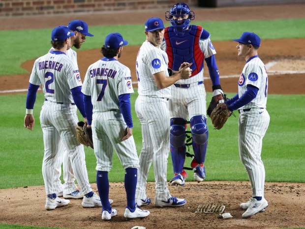 Cubs starting pitcher Matthew Boyd, center, is congratulated by teammates...
