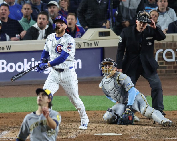 Cubs first baseman Michael Busch watches his solo home run...