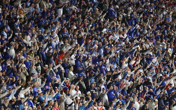 Fans sing "Take Me Out to the Ball Game" during...